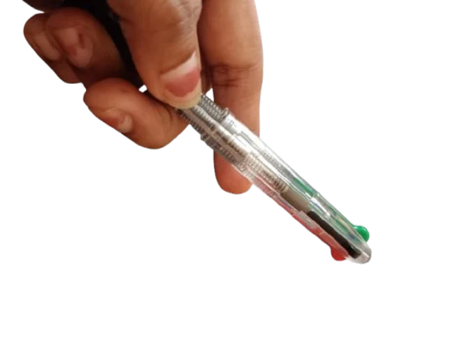A hand pressing the color selector of a multi color pen