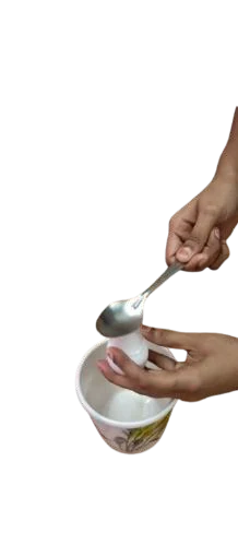 A spoon striking the capped egg over a bowl