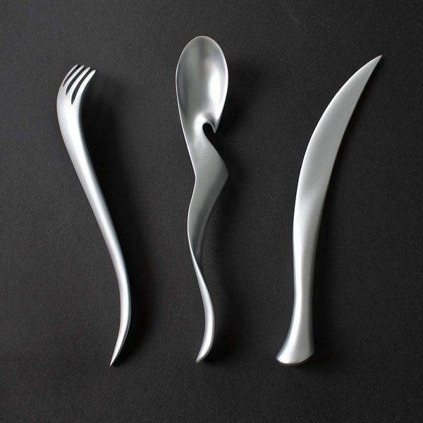 Curved matte silver cutlery on a black background
