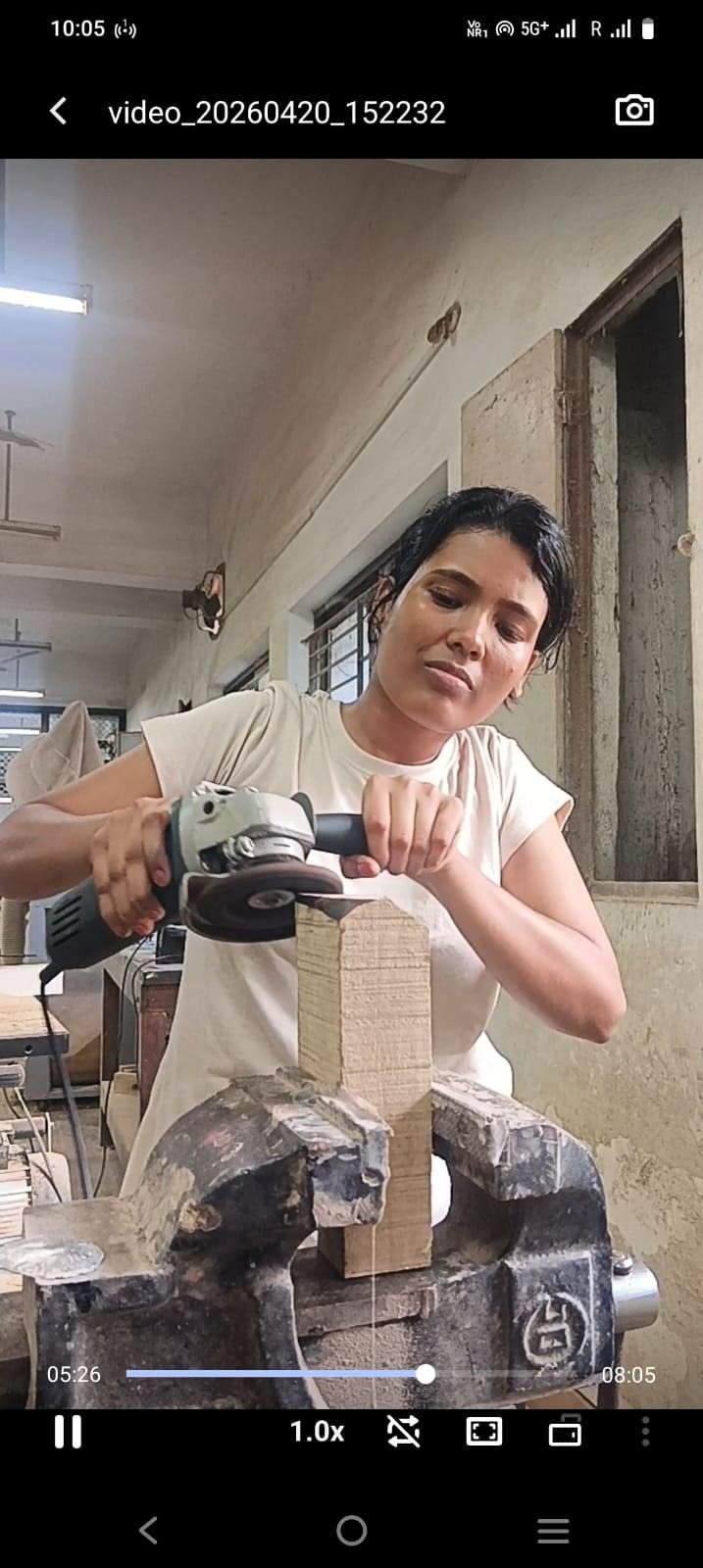 Angle grinding a wooden mold held in a vice