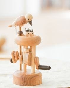A wooden bird automaton on a turned wooden stand